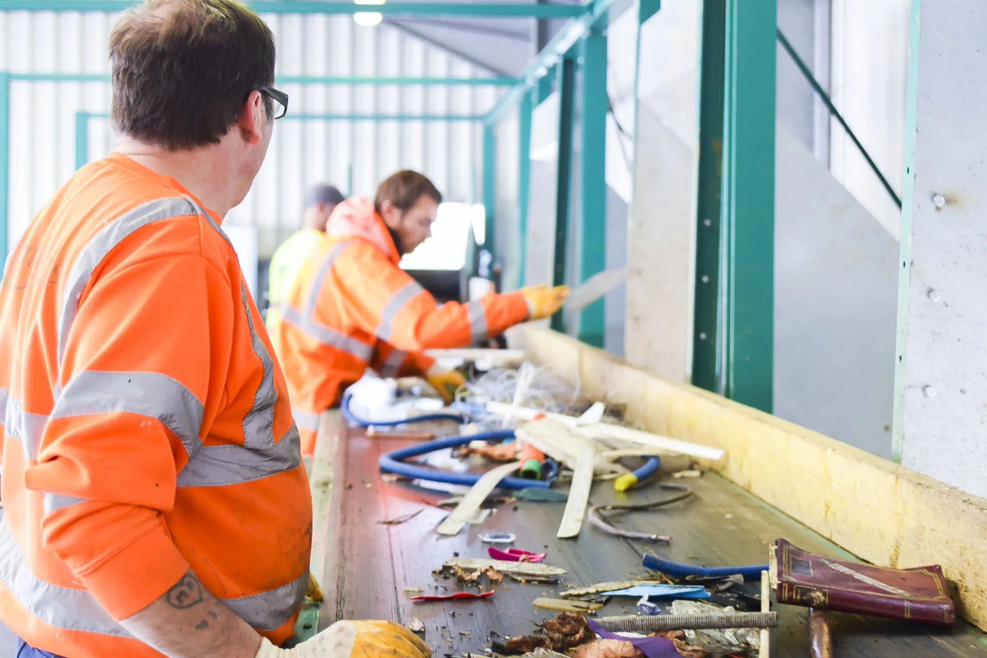 Operators at a manual waste sorting line